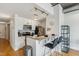 Modern kitchen with white cabinets, granite countertops, and breakfast bar seating at 444 S Blount St # 209, Raleigh, NC 27601