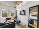 Cozy living area with a comfy couch, large windows, and hardwood floors at 444 S Blount St # 209, Raleigh, NC 27601