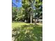 Lush backyard with an outbuilding, offering a private and serene outdoor space for relaxation and activities at 5 Sue Ann Ct, Durham, NC 27704