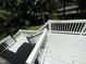 Spacious outdoor deck painted white and light gray, with wood railing overlooking a green, wooded yard at 5 Sue Ann Ct, Durham, NC 27704