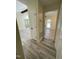 Open hallway connecting various living spaces, featuring durable flooring and fresh paint, promoting seamless flow at 5 Sue Ann Ct, Durham, NC 27704