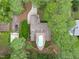 Aerial view displaying private home, inviting backyard pool, and wooded surroundings at 502 Hillcrest Rd, Apex, NC 27502
