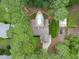 A house is nestled among lush trees, complemented by a private pool and recreational area at 502 Hillcrest Rd, Apex, NC 27502