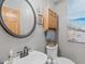 This bathroom has a decorative round mirror and single sink vanity at 502 Hillcrest Rd, Apex, NC 27502