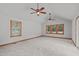 Spacious bedroom with neutral carpet, vaulted ceiling, two ceiling fans, and natural light from three windows at 502 Hillcrest Rd, Apex, NC 27502