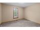 This bedroom has neutral walls, carpet, and a window letting in natural light at 502 Hillcrest Rd, Apex, NC 27502