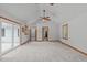 Large bedroom with neutral carpet, wood trim, two ceiling fans, and a sliding glass door to the patio at 502 Hillcrest Rd, Apex, NC 27502