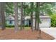 Charming single-story home with a well-maintained lawn, light grey siding, and a two-car garage surrounded by mature trees at 502 Hillcrest Rd, Apex, NC 27502