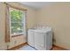 This laundry room features a window with a new washer and dryer at 502 Hillcrest Rd, Apex, NC 27502