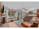 Bright living room with a stone fireplace, plush seating, and views of the outdoor pool at 502 Hillcrest Rd, Apex, NC 27502