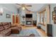 Cozy living room featuring a stone fireplace, wood floors, and plenty of natural light at 502 Hillcrest Rd, Apex, NC 27502