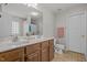 Bathroom featuring double vanity with wood cabinets and tile flooring at 504 Ashburn Ln, Durham, NC 27703