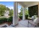 Inviting front porch with stately columns and comfortable seating area at 504 Ashburn Ln, Durham, NC 27703