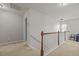 Upstairs hallway featuring neutral walls, carpet, and wood-trimmed banister at 504 Ashburn Ln, Durham, NC 27703