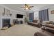 Cozy living room with plush seating, a fireplace, and large windows for natural light at 504 Ashburn Ln, Durham, NC 27703