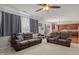 Comfortable living room featuring plush seating, a ceiling fan, and natural light at 504 Ashburn Ln, Durham, NC 27703