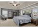 Comfortable main bedroom with a tray ceiling, ceiling fan, and carpet at 504 Ashburn Ln, Durham, NC 27703