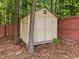 A backyard shed with a double door and window at 504 Ashburn Ln, Durham, NC 27703