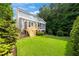 Well-maintained backyard with lush green grass, a wooden deck, and mature trees at 508 Morning Oaks Dr, Holly Springs, NC 27540