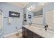 A bathroom features double sinks, a large mirror, a toilet, and a shower with blue accents at 508 Morning Oaks Dr, Holly Springs, NC 27540
