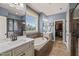 A luxurious primary bathroom features dual sinks, a soaking tub, and a separate shower with blue walls at 508 Morning Oaks Dr, Holly Springs, NC 27540