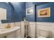 Stylish powder room features blue wallpaper, vanity with gold faucet, and modern fixtures at 508 Morning Oaks Dr, Holly Springs, NC 27540
