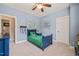 A cheerful bedroom features a ceiling fan, playful decor, and blue walls, providing a cozy space at 508 Morning Oaks Dr, Holly Springs, NC 27540