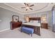 Elegant main bedroom features a king-size bed, a blue bench, and neutral decor at 508 Morning Oaks Dr, Holly Springs, NC 27540