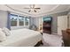 Comfortable bedroom with large windows, a ceiling fan, and a stylish accent chair at 508 Morning Oaks Dr, Holly Springs, NC 27540
