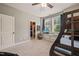 A large bedroom features a bunk bed, ceiling fan, walk-in closet, a TV on the windowsill, and carpeted floors at 508 Morning Oaks Dr, Holly Springs, NC 27540