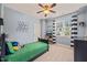 A bright bedroom features a ceiling fan, window, and playful decor, perfect for a room at 508 Morning Oaks Dr, Holly Springs, NC 27540