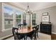 Bright dining area with large windows, modern lighting, and elegant furnishings at 508 Morning Oaks Dr, Holly Springs, NC 27540