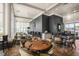 Elegant dining room with a mix of round and square tables, comfortable seating, and modern decor at 508 Morning Oaks Dr, Holly Springs, NC 27540