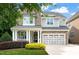Charming two-story home with stone and siding, a welcoming porch, and a two-car garage at 508 Morning Oaks Dr, Holly Springs, NC 27540