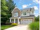 Charming home with stone and siding, a covered porch, and a two-car garage at 508 Morning Oaks Dr, Holly Springs, NC 27540