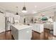 Modern kitchen with stainless appliances, dual islands, and view into the living space at 508 Morning Oaks Dr, Holly Springs, NC 27540