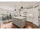 Well-lit kitchen showcases a center island, stainless steel appliances, and seamless connection to the dining area at 508 Morning Oaks Dr, Holly Springs, NC 27540