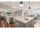 Open concept kitchen with large center islands, stainless steel appliances, and seamless flow to living and dining areas at 508 Morning Oaks Dr, Holly Springs, NC 27540