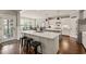 Bright kitchen with white cabinets, an island with bar seating, and stainless steel appliances at 508 Morning Oaks Dr, Holly Springs, NC 27540