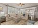 Open-concept living space with a large sectional sofa and a view into the bright, modern kitchen at 508 Morning Oaks Dr, Holly Springs, NC 27540