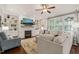 Comfortable living room with fireplace, built-in shelving, and large windows for natural light at 508 Morning Oaks Dr, Holly Springs, NC 27540