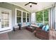 Relaxing screened porch with comfortable seating, outdoor rug, ceiling fan, and natural light at 508 Morning Oaks Dr, Holly Springs, NC 27540