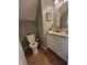 Bathroom features a toilet, vanity with a sink, a mirror, gray walls, and brown tiled floor at 5126 Thornton Knoll Way, Raleigh, NC 27616