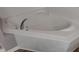 A close up view of the a bathtub with white tiling at 5126 Thornton Knoll Way, Raleigh, NC 27616