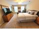 Carpeted bedroom, natural light, dresser with television, and a comfortable bed for relaxation at 5126 Thornton Knoll Way, Raleigh, NC 27616