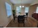 Dining room with modern lighting, table, chairs, and bright windows at 5126 Thornton Knoll Way, Raleigh, NC 27616