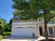 Two-story home featuring a two-car garage and a well-maintained lawn at 5126 Thornton Knoll Way, Raleigh, NC 27616