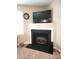 Close-up of the fireplace with a TV above, and a decorative clock at 5126 Thornton Knoll Way, Raleigh, NC 27616