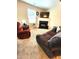 Carpeted living room with fireplace, TV, sofa, and large window at 5126 Thornton Knoll Way, Raleigh, NC 27616