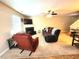 Wide view of the living room with sofa, recliner, piano, and fireplace at 5126 Thornton Knoll Way, Raleigh, NC 27616
